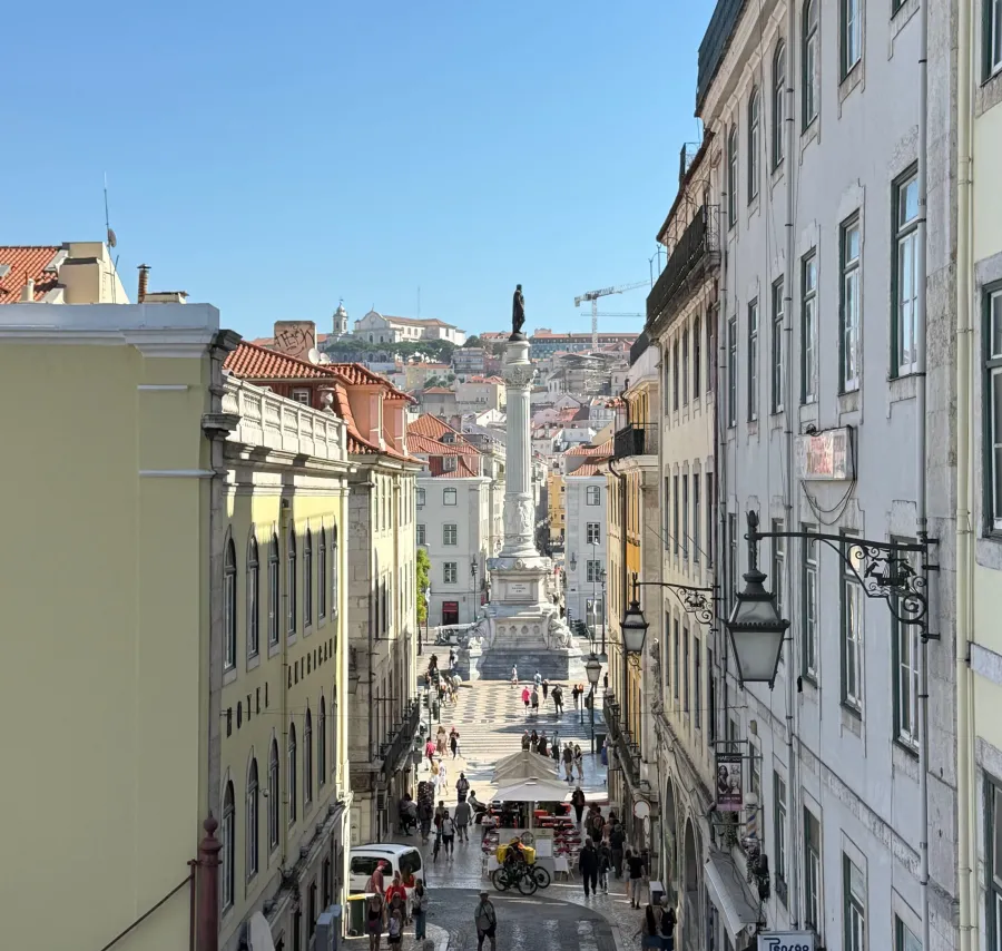 Lisbon’s Rossio Square framed by pastel buildings and the Pedro IV monument