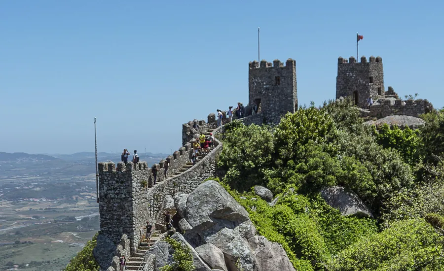 Medieval stone walls and towers of the Moorish Castle winding along Sintra’s rocky ridge